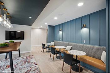 a restaurant with tables and chairs and a wall with a bunch of chairs