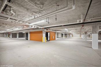 an empty underground parking garage with yellow and orange walls
