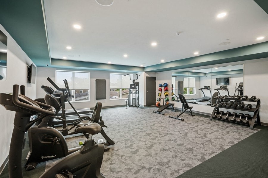 A spacious gym with a variety of exercise equipment.