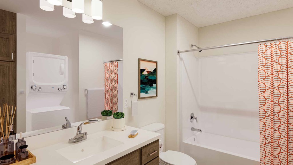 A bathroom with a white sink and orange curtains.