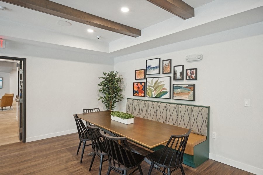 A dining room with a wooden table and chairs.