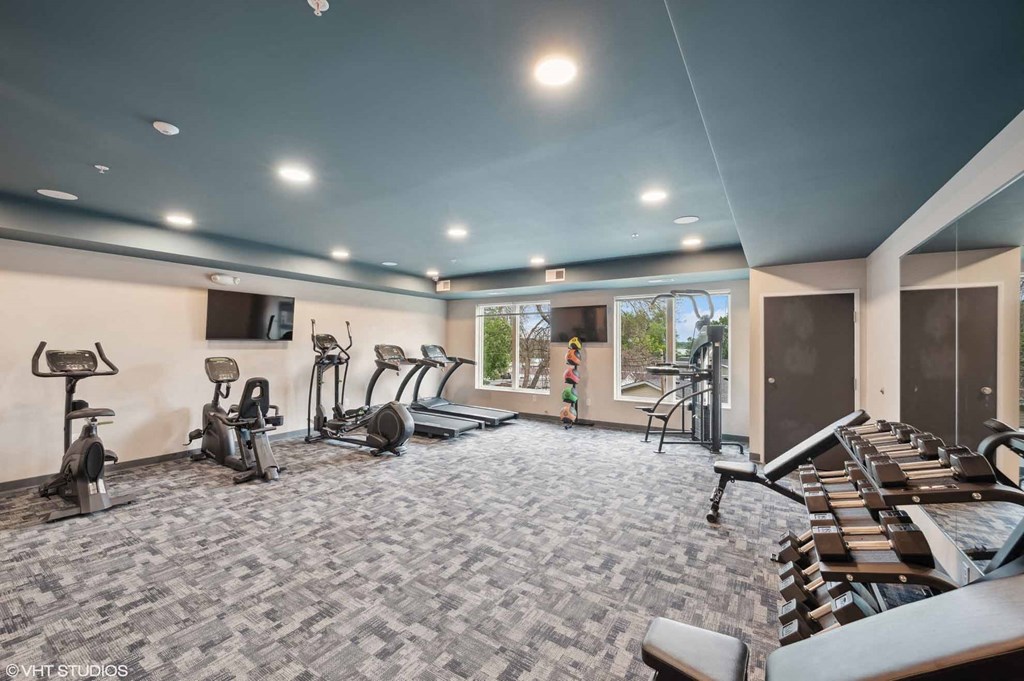 A spacious gym with a variety of exercise equipment.