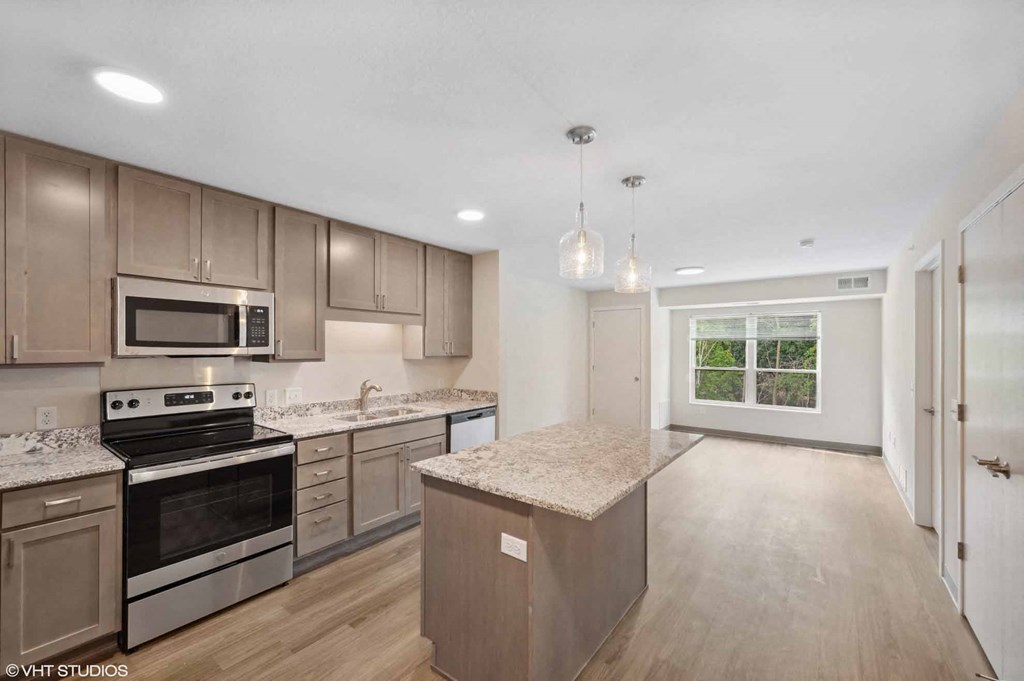 A kitchen with wooden cabinets and granite countertops.
