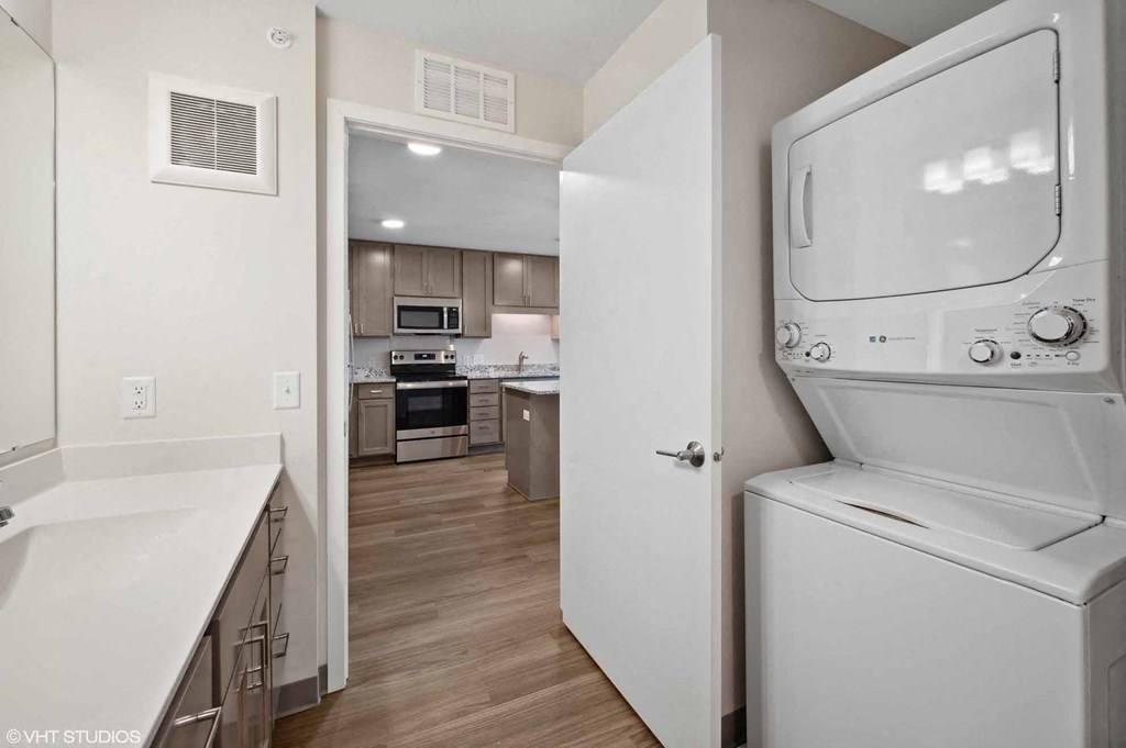 A white oven is in a kitchen with a microwave and other appliances.