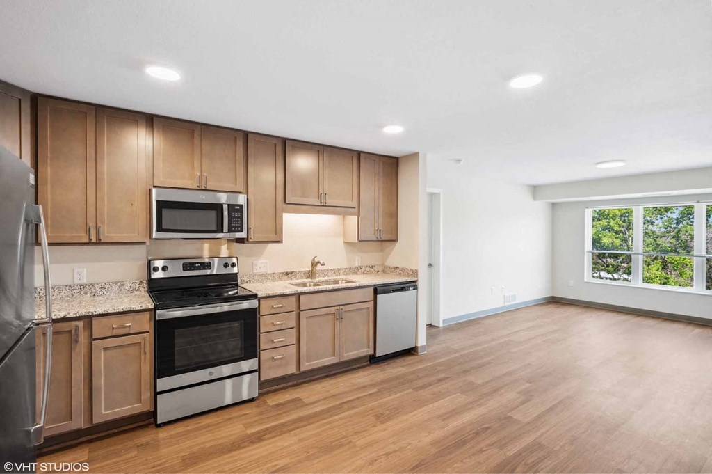 A kitchen with wooden cabinets and stainless steel appliances.