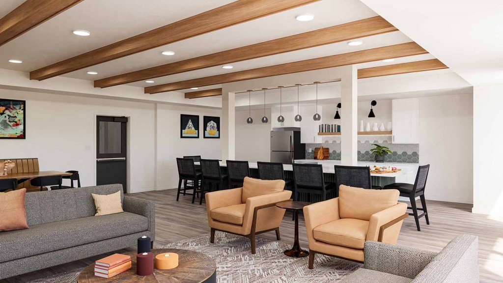 A living room with a grey sofa, black chairs, and a coffee table.