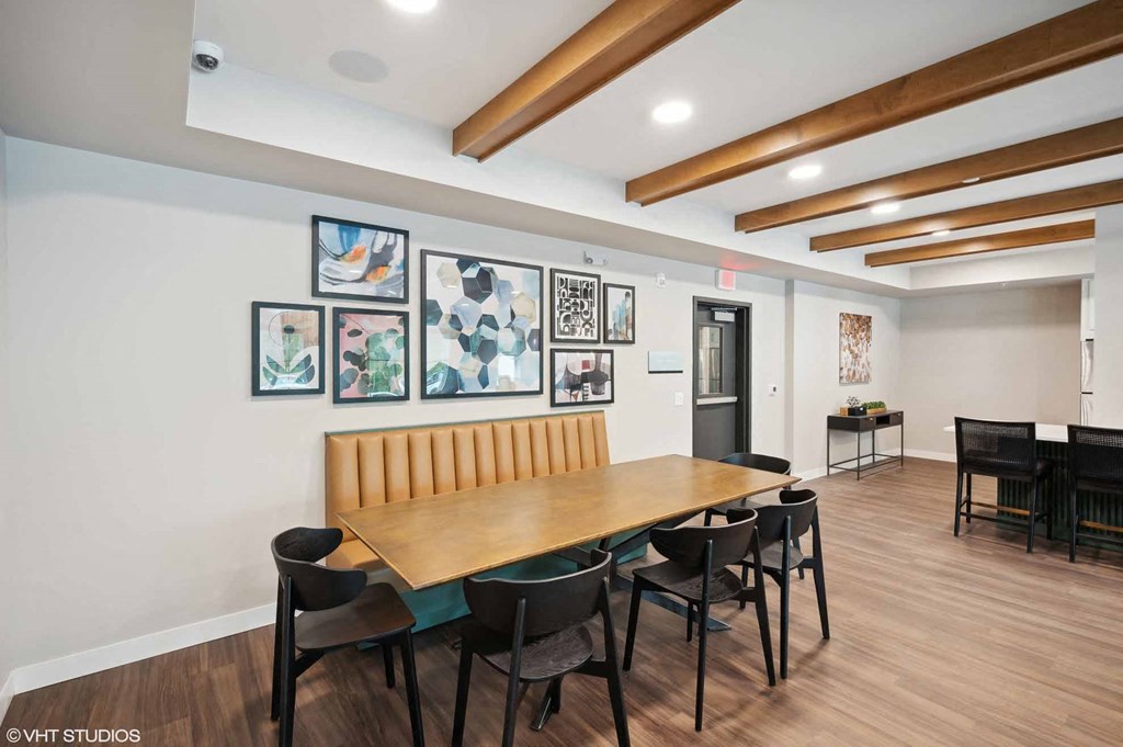 A conference room with a long table and chairs.