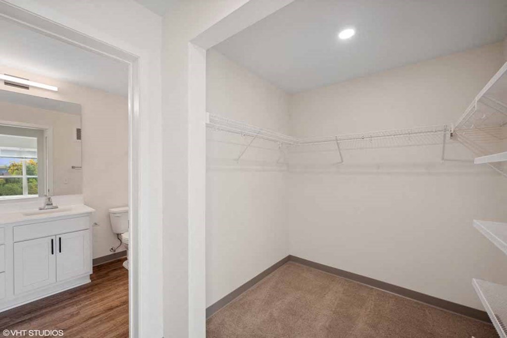 a bathroom with a sink and a toilet in a white room