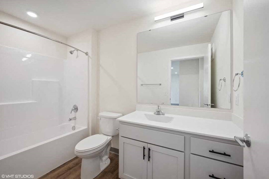 a bathroom with a sink and a toilet and a mirror