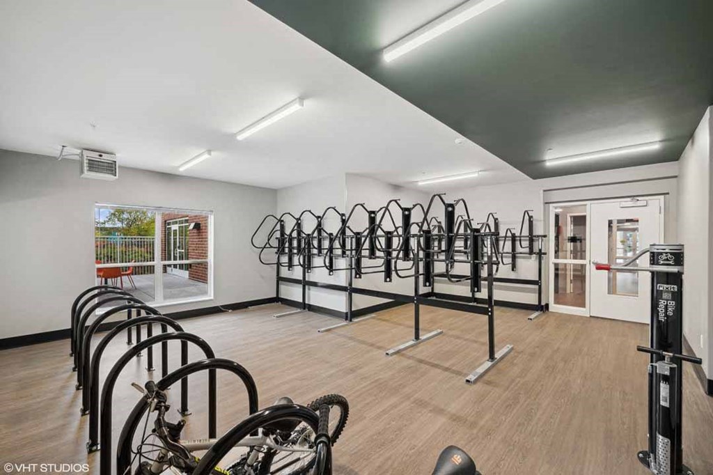 A gym with a row of exercise bikes.