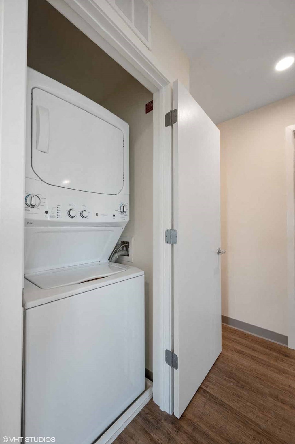 A white dryer is in a small room.