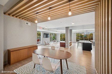 A modern dining room with a round table and chairs.