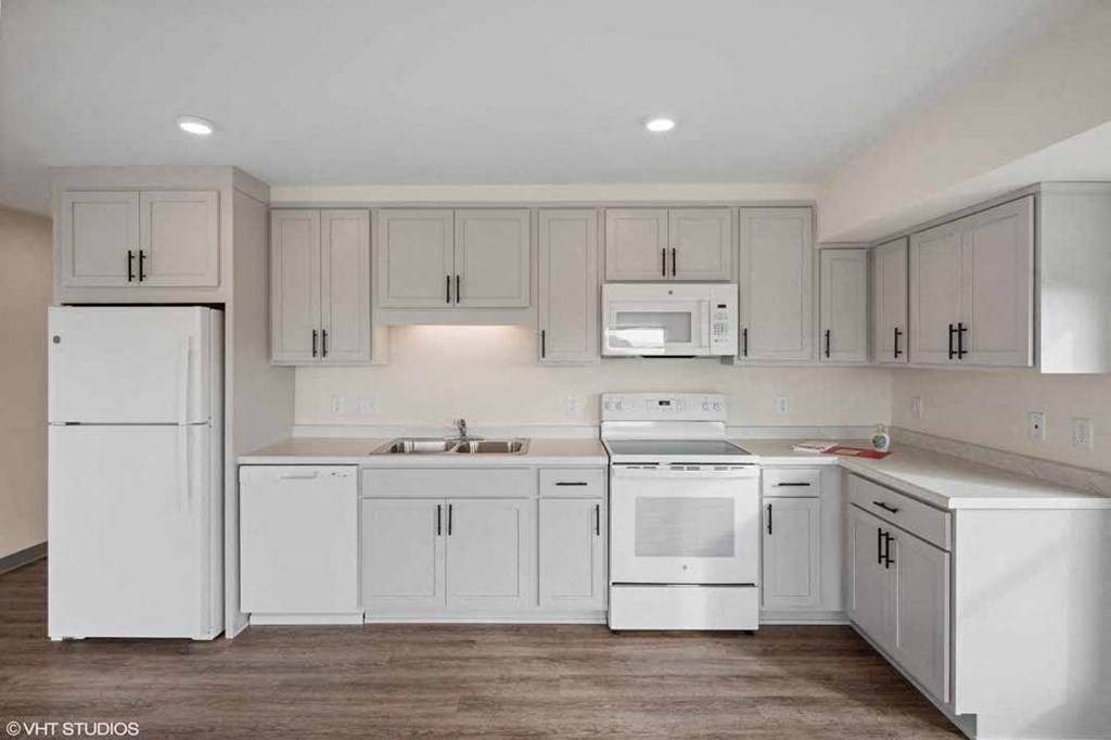 a white kitchen with white appliances and white cabinets