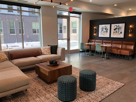 a lobby with couches and chairs and a table