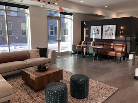 a lobby with couches and chairs and a table