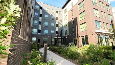 a sidewalk in front of an apartment building