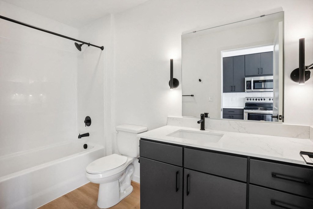 A bathroom with a white toilet and a white sink.