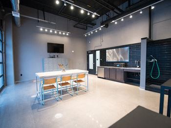 a large room with a table and chairs and a tv