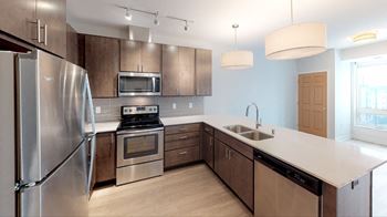 a kitchen with stainless steel appliances and wooden cabinets