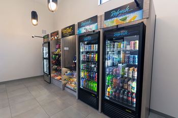 A row of three refrigerators are lined up in a row.