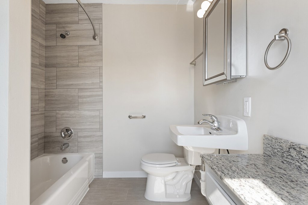 A white toilet sits next to a sink in a bathroom.
