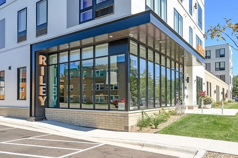 A modern building with a glass facade and a sign that reads "RILEY".