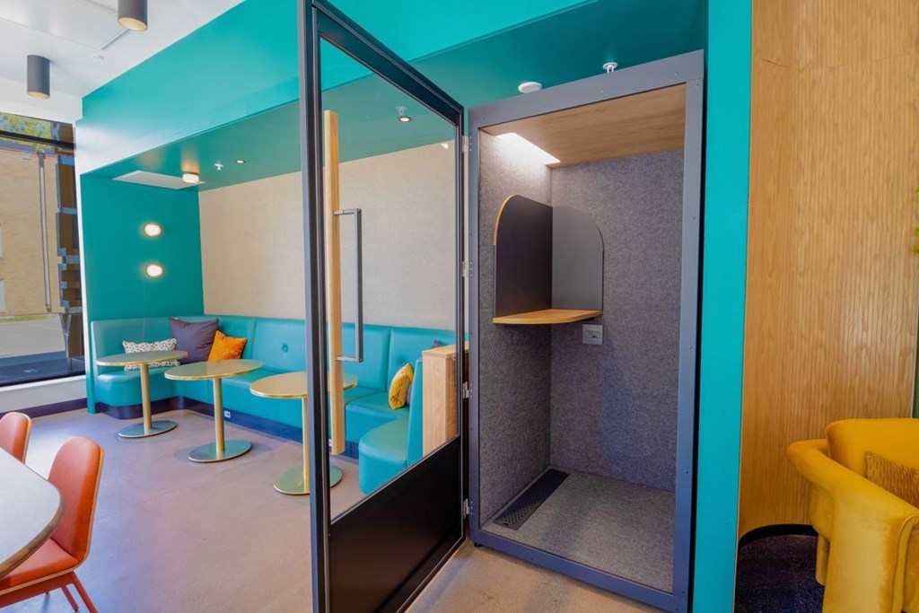 A room with a blue wall and a yellow chair.