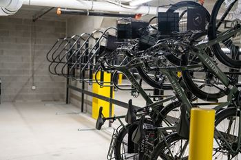 A bike rack with many bicycles parked.