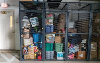 A storage room with a metal gate and boxes.