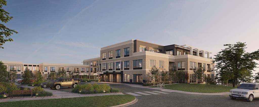 A modern building with a parking lot in front.