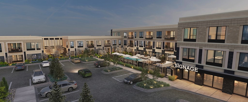 A parking lot in front of a building with a sign that reads "Signage".