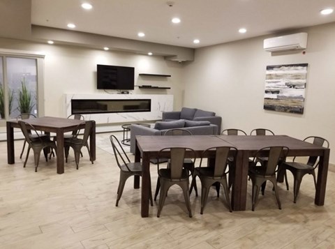A modern dining room with a large table and chairs.