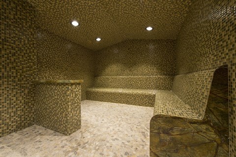 a large steam room with a bench