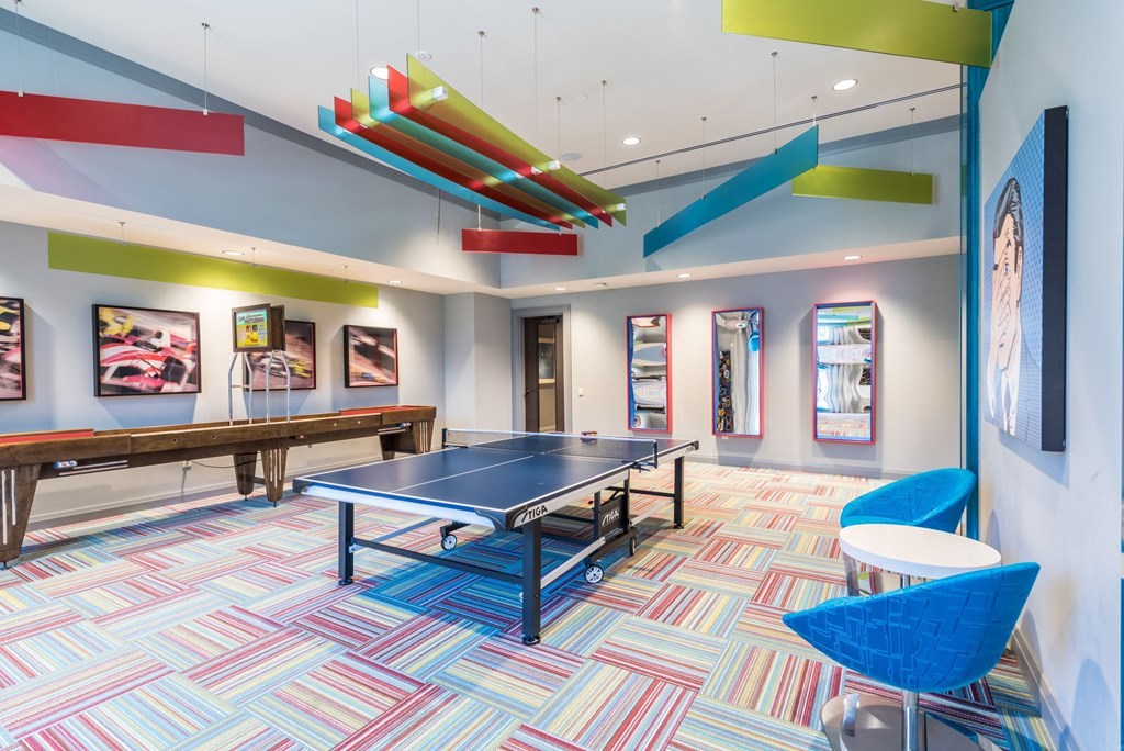 a game room with a ping pong table and shuffleboard table