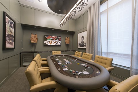 a poker table in a room with large windows