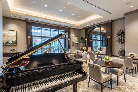 a piano sits in the middle of a large ballroom
