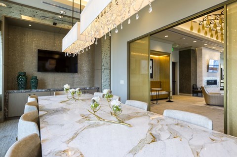 a long conference table in an elegant room with large windows