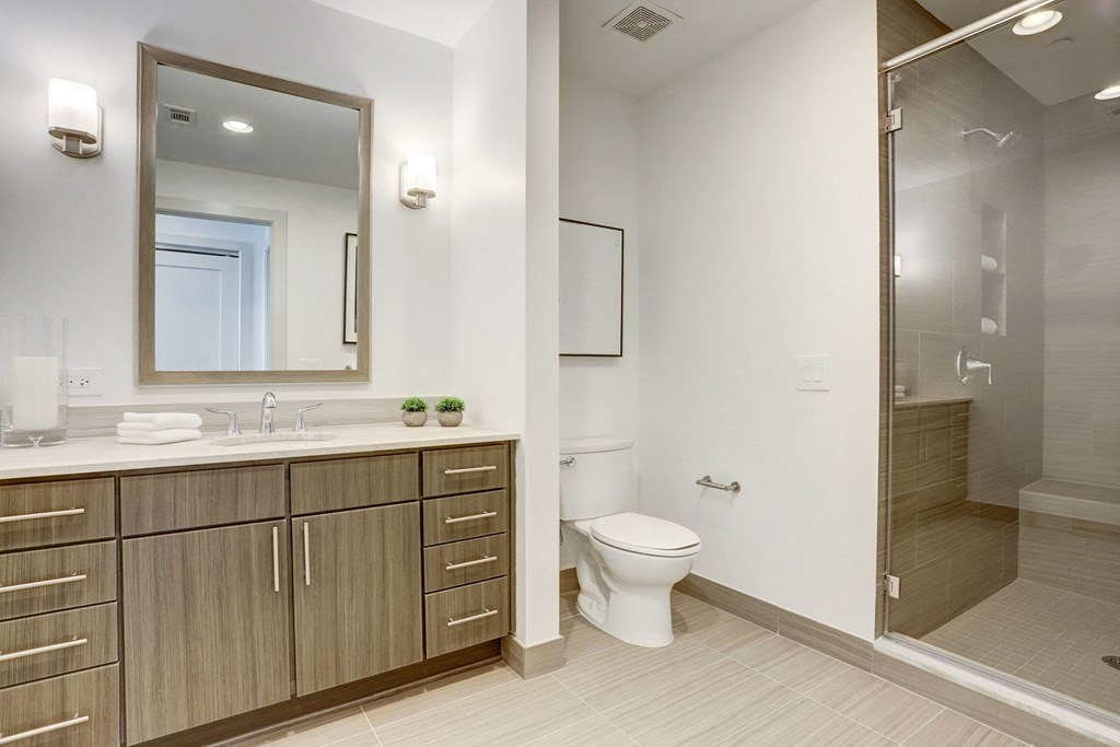 a bathroom with a toilet sink and shower