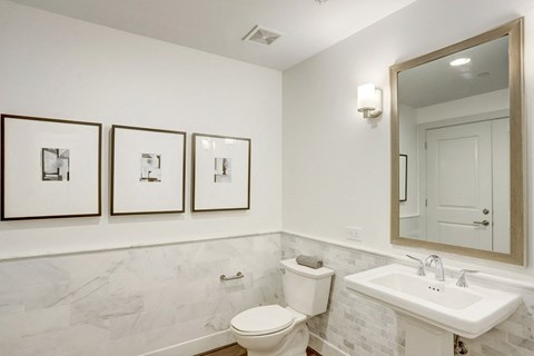 a bathroom with a toilet sink and mirror