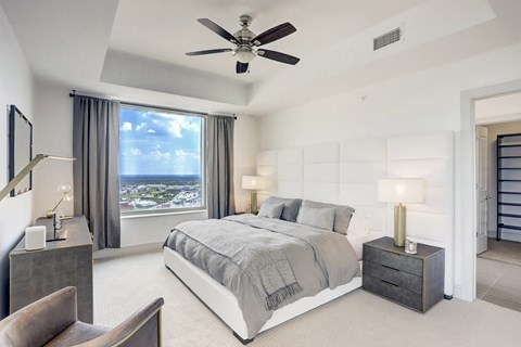 a bedroom with a bed and a ceiling fan at Market square tower in downtown houston