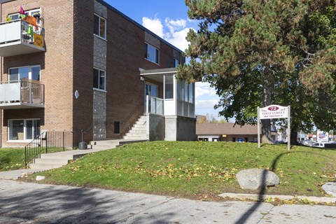 a large brick building with a sign in front of it