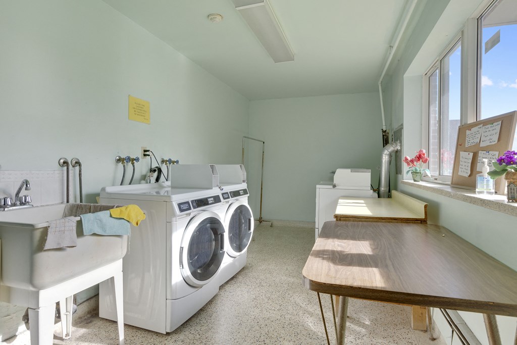 a laundry room with a sink and a washing machine