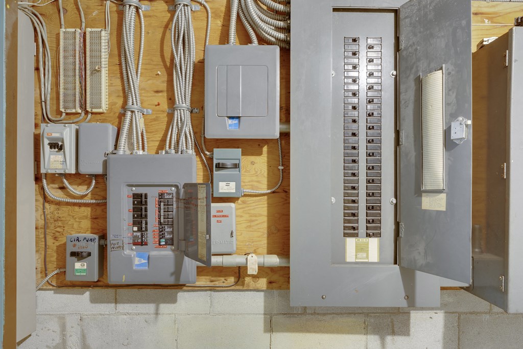 an array of electrical equipment hangs on a wall
