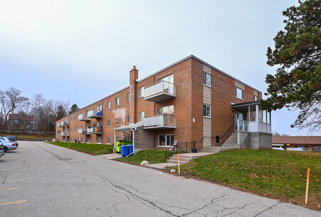 a red brick apartment building with balconies