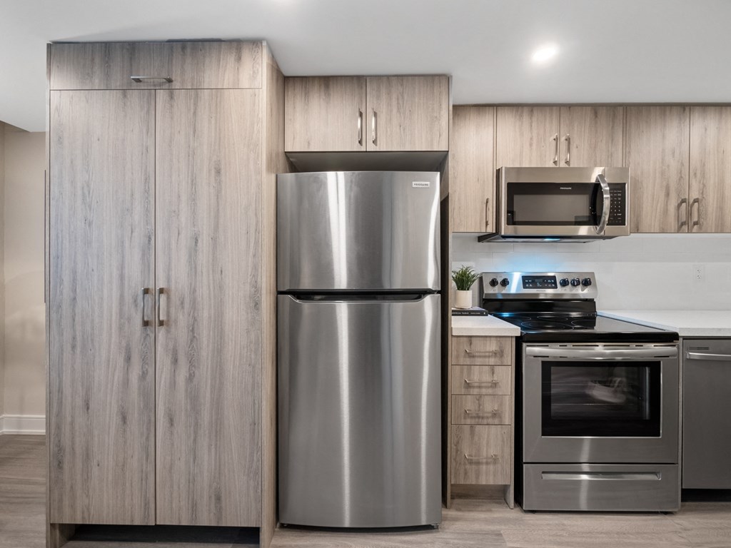 a kitchen with stainless steel appliances and wooden cabinets