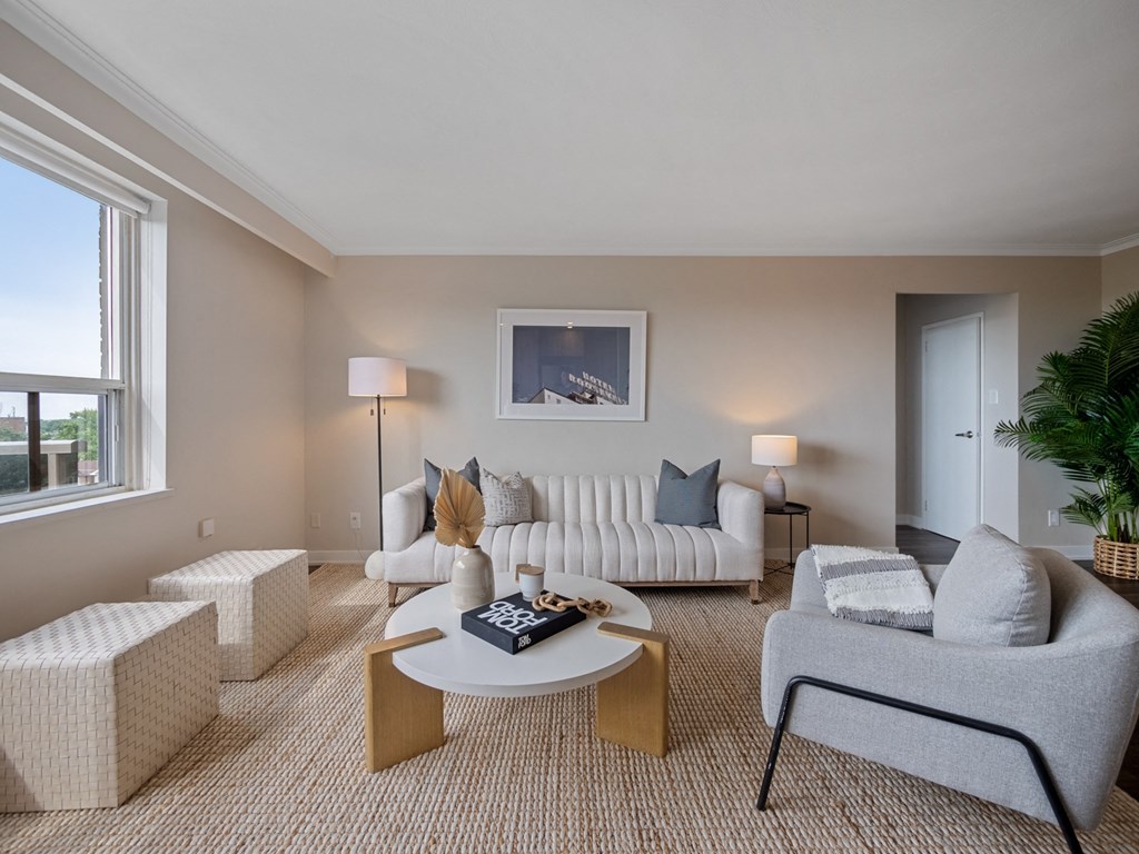 a living room filled with furniture and a large window