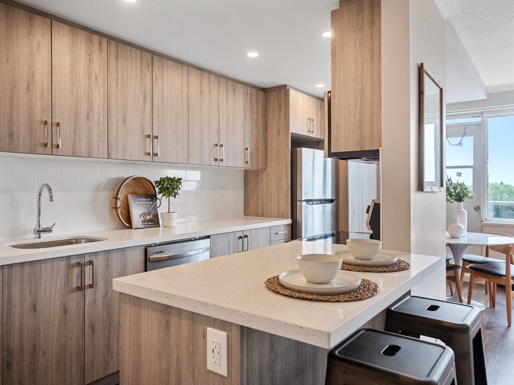a kitchen with white countertops and wooden cabinets