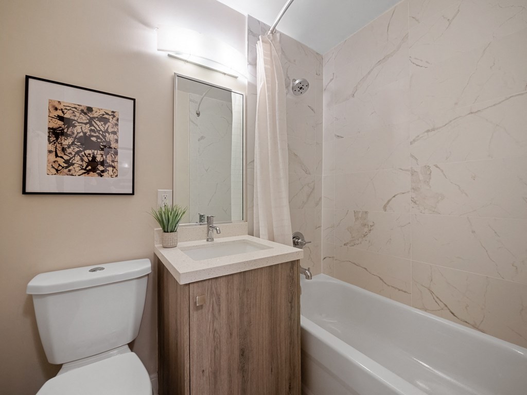 a bathroom with a sink toilet and bathtub