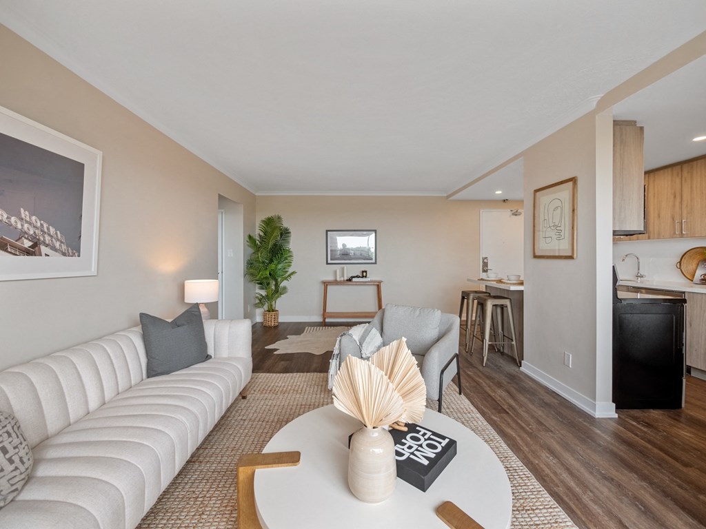 a living room with a white couch and a white coffee table