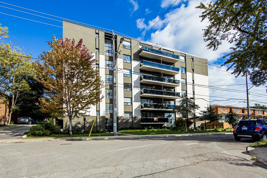 an image of an apartment building with a blue sky in the background